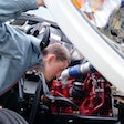 driver inspecting a diesel engine