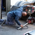 Man jacking up the rear of a semi