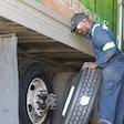 man changing a trailer tire